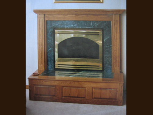 Picture 3 of 6, a marble fireplace with an oak frame.